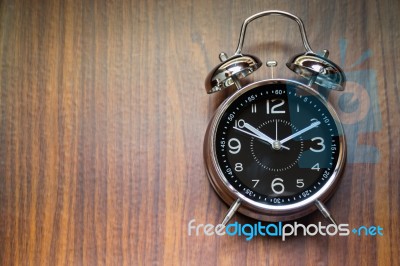 Alarm Clock On Wooden Background Stock Photo