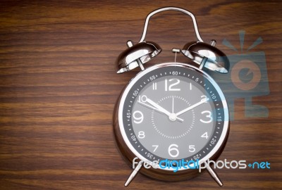 Alarm Clock On Wooden Background Stock Photo