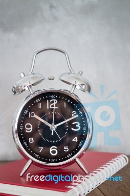 Alarm Clock On Wooden Work Table Stock Photo