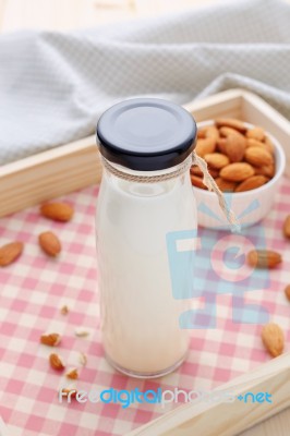 Almond Milk In Bottle With Almonds On Wood Tray Stock Photo