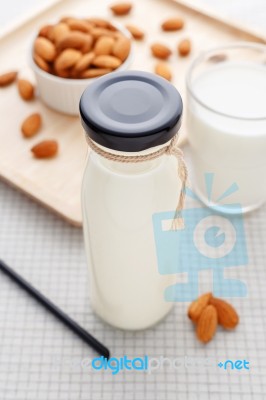 Almond Milk In Bottle With Straw And Almonds Stock Photo