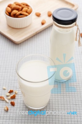 Almond Milk In Glass And Bottle With Almonds On Table Stock Photo