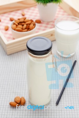 Almond Milk In Glass Bottle With Almonds Stock Photo