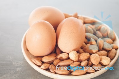 Almond Nuts And Eggs On Wooden Plate Stock Photo