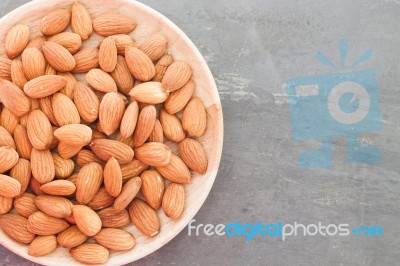 Almond Nuts On Wooden Plate Stock Photo