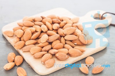 Almond Nuts On Wooden Plate Stock Photo