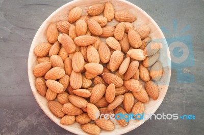 Almond Nuts On Wooden Plate Stock Photo