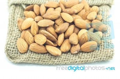 Almonds In Sack Isolated On White Background Stock Photo