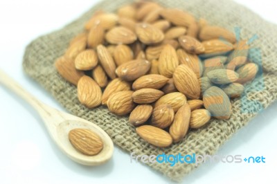 Almonds In Sack Isolated On White Background Stock Photo