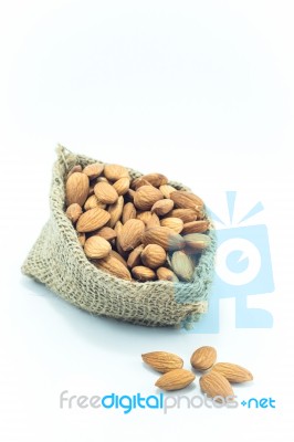 Almonds In Sack Isolated On White Background Stock Photo