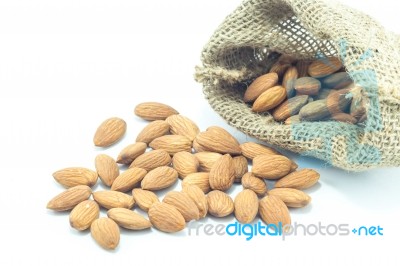 Almonds In Sack Isolated On White Background Stock Photo