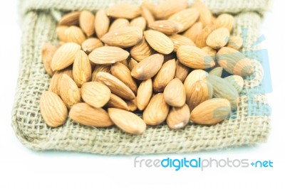 Almonds In Sack Isolated On White Background Stock Photo