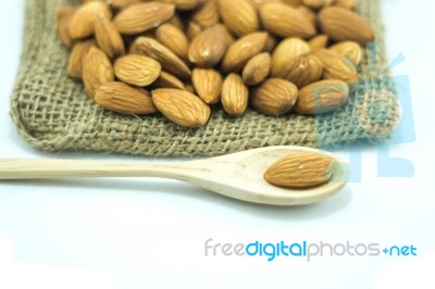 Almonds In Sack Isolated On White Background Stock Photo