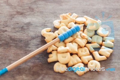 Alphabet Biscuit In Wooden Table Stock Photo