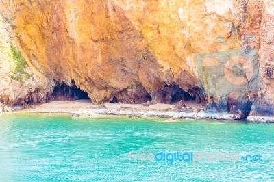 Amazing Rocky Coastline With Cave And Pristine Blue Water Stock Photo