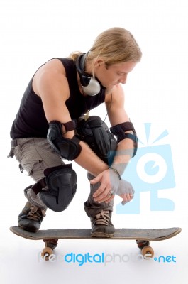 American Male Sitting On Skateboard Stock Photo