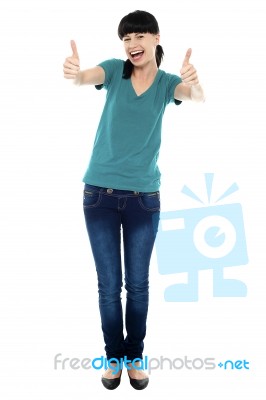 Amused Woman Gesturing Double Thumbs Up Stock Photo