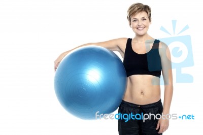 An Attractive Fit Lady Holding Blue Pilates Ball Stock Photo