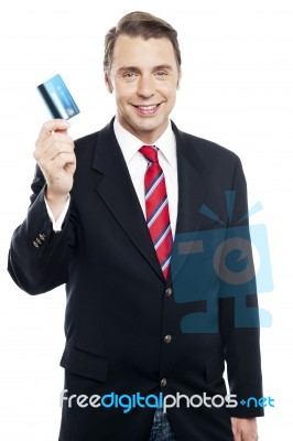 An Entrepreneur Showing Debit Card To Camera Stock Photo