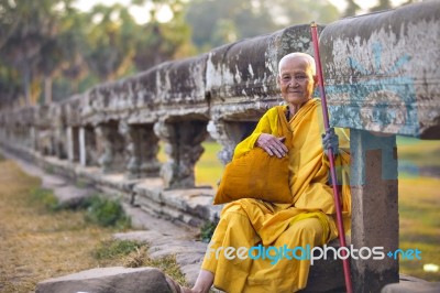 An Unidentified Old Buddhist Female Monk Dressed In Orange Toga Stock Photo