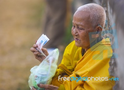 An Unidentified Old Buddhist Female Monk Dressed In Yellow Toga Stock Photo