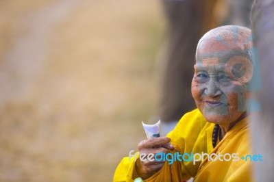 An Unidentified Old Buddhist Female Monk Dressed In Yellow Toga Stock Photo