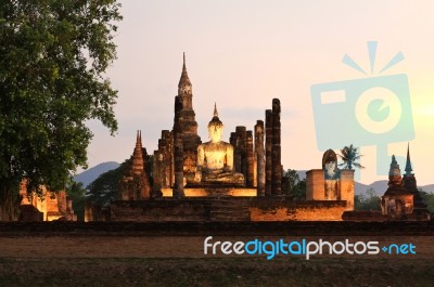 Ancient Buddha Statue At Twilight, Wat Mahathat In Sukhothai His… Stock Photo