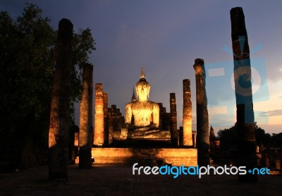 Ancient Buddha Statue At Twilight, Wat Mahathat In Sukhothai His… Stock Photo