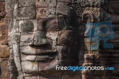 Ancient Stone Face Of Bayon Temple Stock Photo