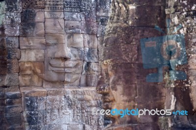 Ancient Stone Face Of Bayon Temple Stock Photo