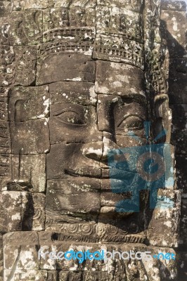 Ancient Stone Faces Of King Jayavarman Vii At The Bayon Temple, Stock Photo