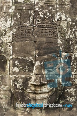 Ancient Stone Faces Of King Jayavarman Vii At The Bayon Temple, Stock Photo