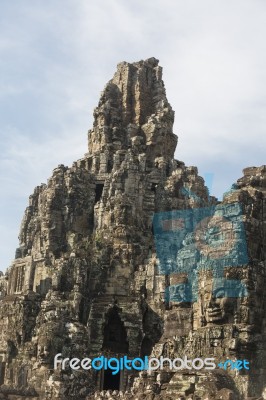 Ancient Stone Faces Of King Jayavarman Vii At The Bayon Temple, Stock Photo