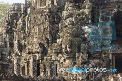 Ancient Stone Faces Of King Jayavarman Vii At The Bayon Temple, Stock Photo