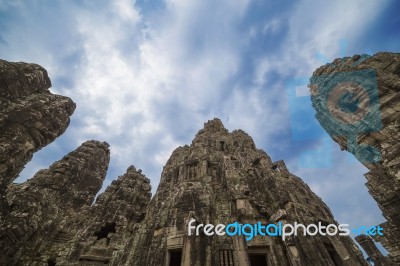 Ancient Stone Faces Of King Jayavarman Vii At The Bayon Temple, Stock Photo