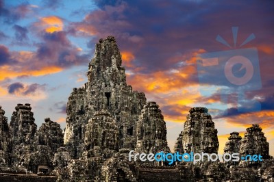 Ancient Stone Faces Of King Jayavarman Vii At The Bayon Temple, Stock Photo