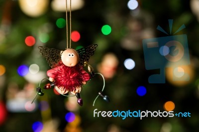 Angel With Christmas Light Ornament Hanging On Christmas Tree Stock Photo