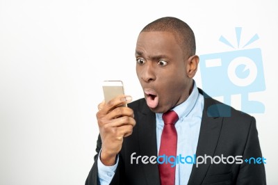 Angry Businessman Reading Text Messages Stock Photo