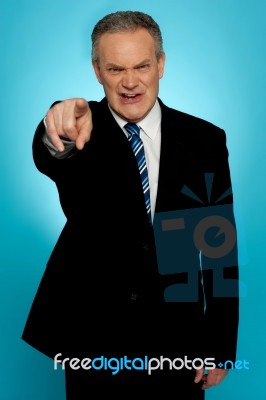 Angry Senior Businessman Pointing Finger At You Stock Photo