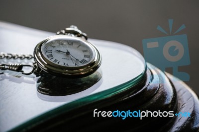 Antique Pocket Watch On Glass Table Stock Photo