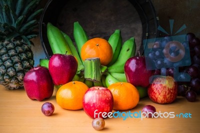 Apple And Several Kinds Of Fruits On A Wooden Stock Photo