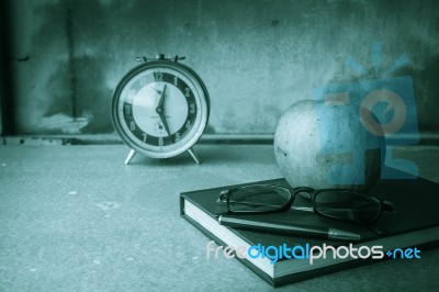 Apple On The Old Book Stock Photo