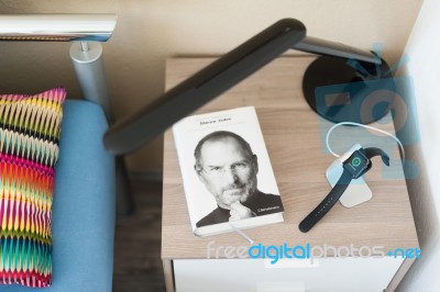 Apple Watch Being Charged On The Bedside Table Stock Photo