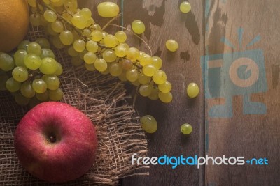 Apples And Grapes On Wooden Stock Photo