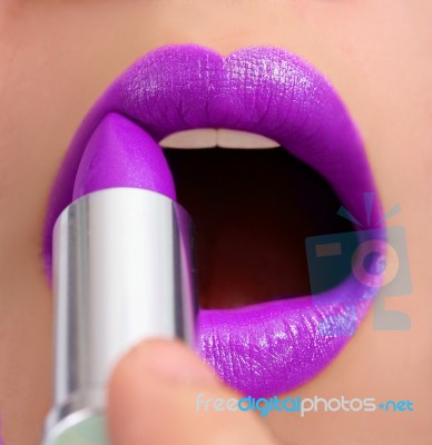 Applying Violet Lipstick Stock Photo