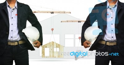 Architect And Construction Crane Lifting Home And Safety Helmet On White Background Use For Construction Industry And Residence Real Estate Land Development Stock Photo