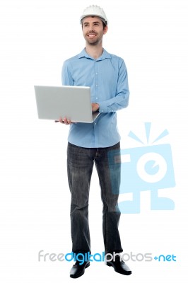 Architect Holding Laptop And Looking Upwards Stock Photo