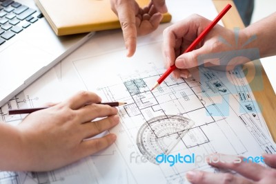 Architects Discussing At The Table With Blueprint - Closeup On H… Stock Photo