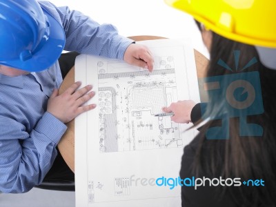 Architects Discussing With Plan Stock Photo