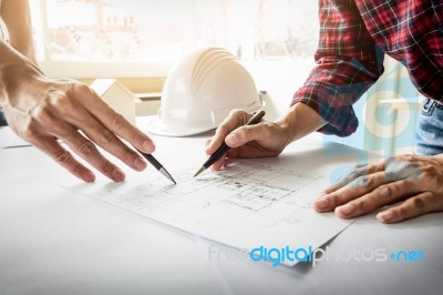 Architects Engineer Discussing At The Table With Blueprint - Clo… Stock Photo